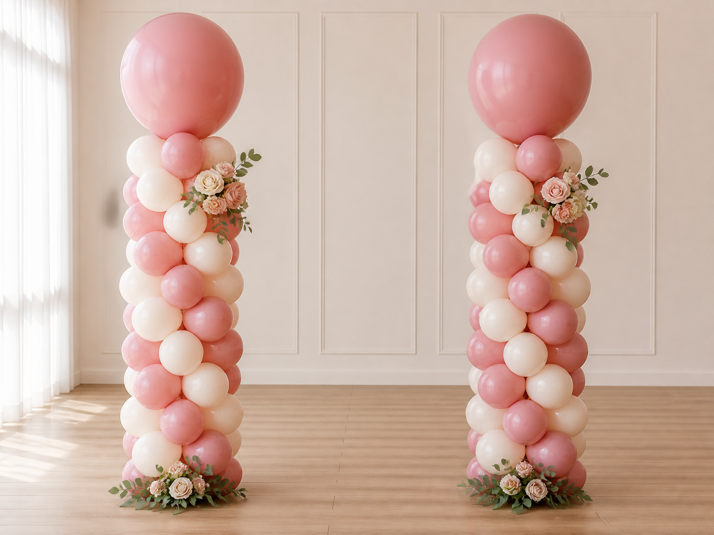 Two freestanding dusty rose and ivory balloon columns with floral accents